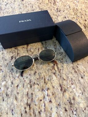 Prada Oval Metal Sunglasses in Gold with Dark Green Lenses